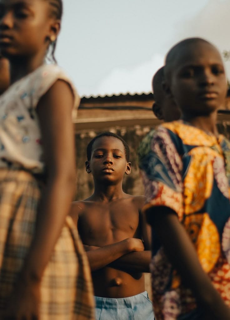 Children standing together in low golden light